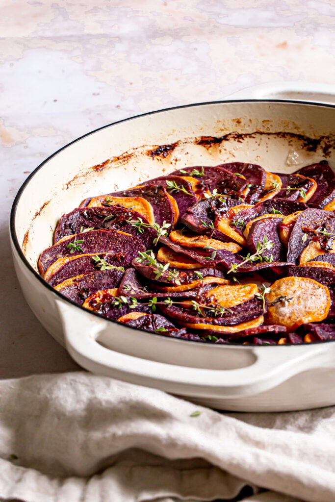 a side view of the browned butter bourbon skillet sweet potatoes roasted in the skillet with a linen napkin.