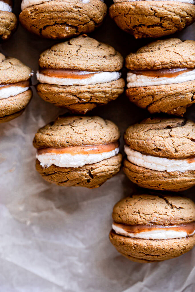 apple butter whoopie pies lined up in a baking pan all in a row