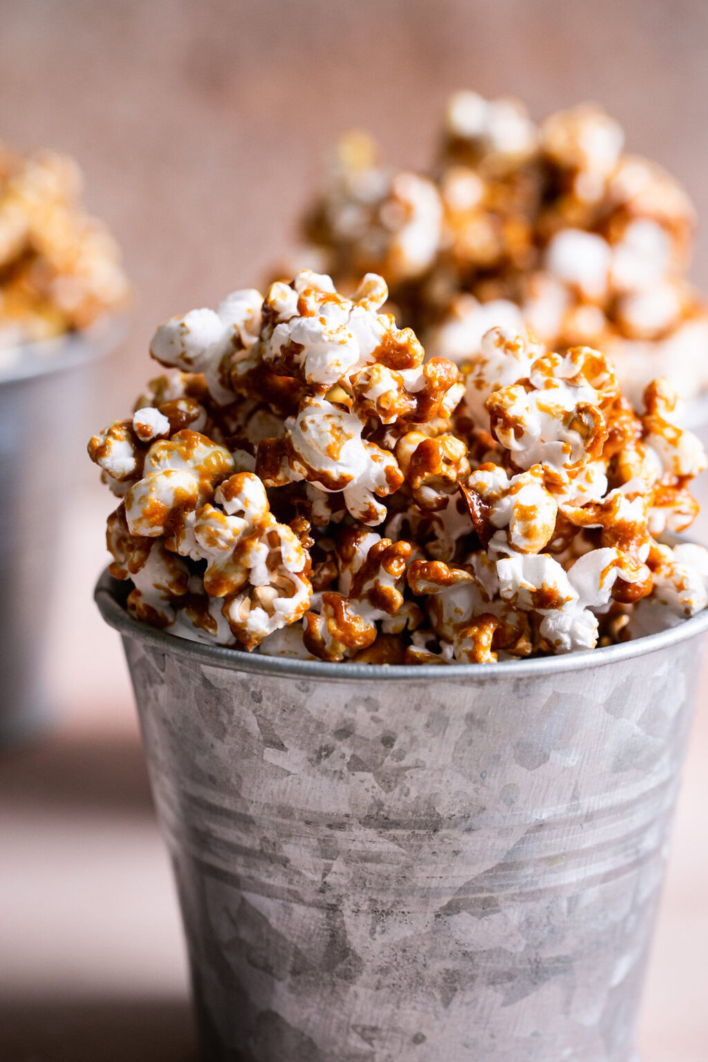 a close up shot of one of the buckets of caramel popcorn