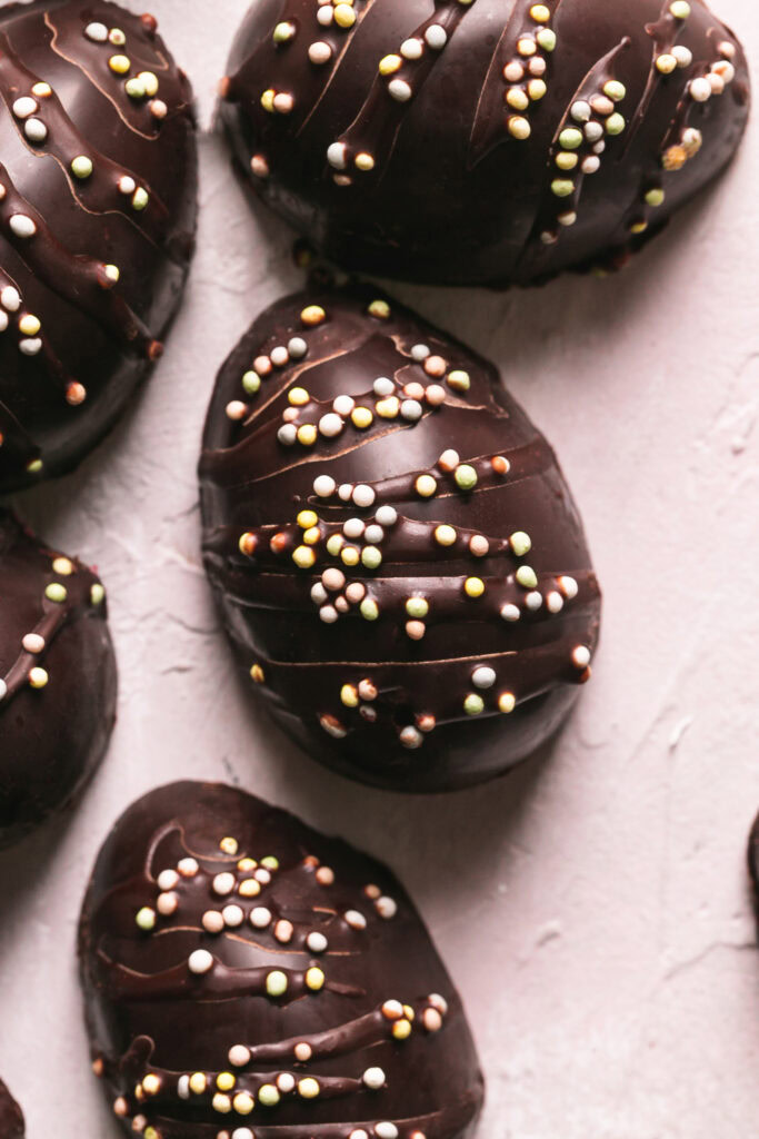 an overhead image of chocolate eggs decorated with sprinkles