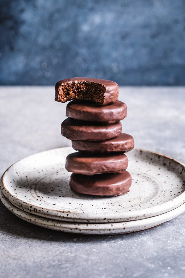 a stack of thin mint cookies on a plate with a bite taken out of the top cookie