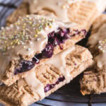 a close up of the blueberry inside of a pop tart frosted and sprinkled