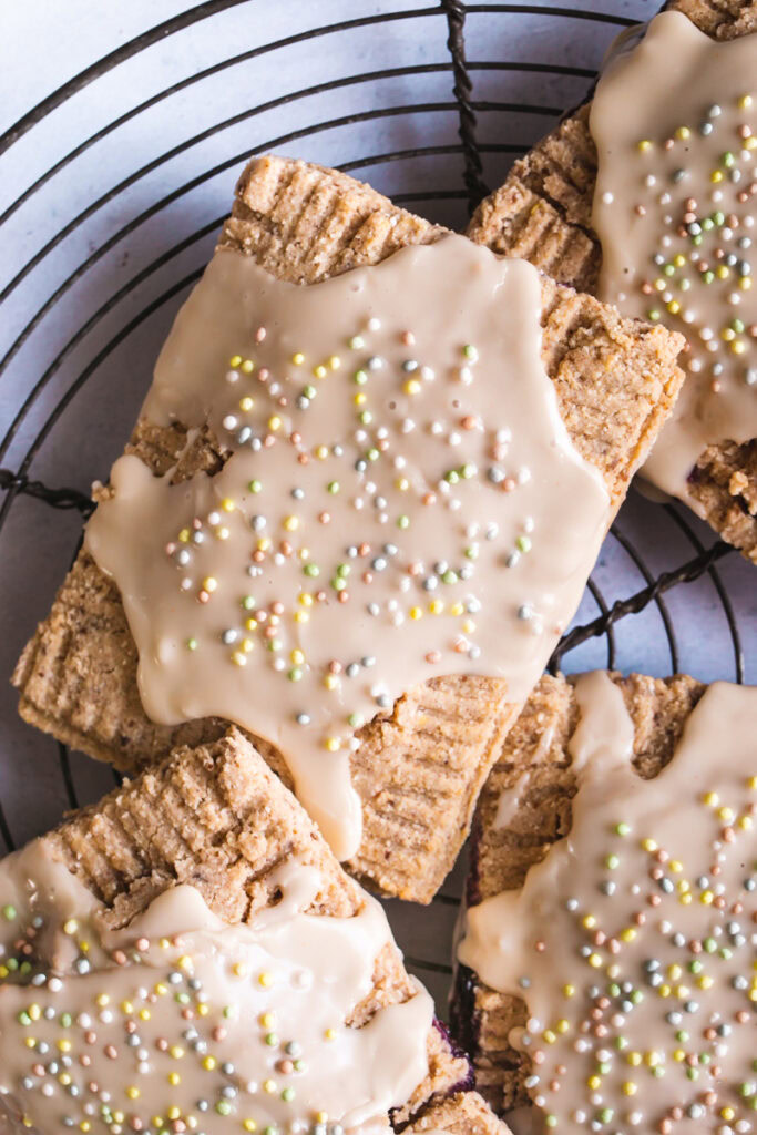 a flatlay close up shot of frosted pop tarts with colored sprinkles 