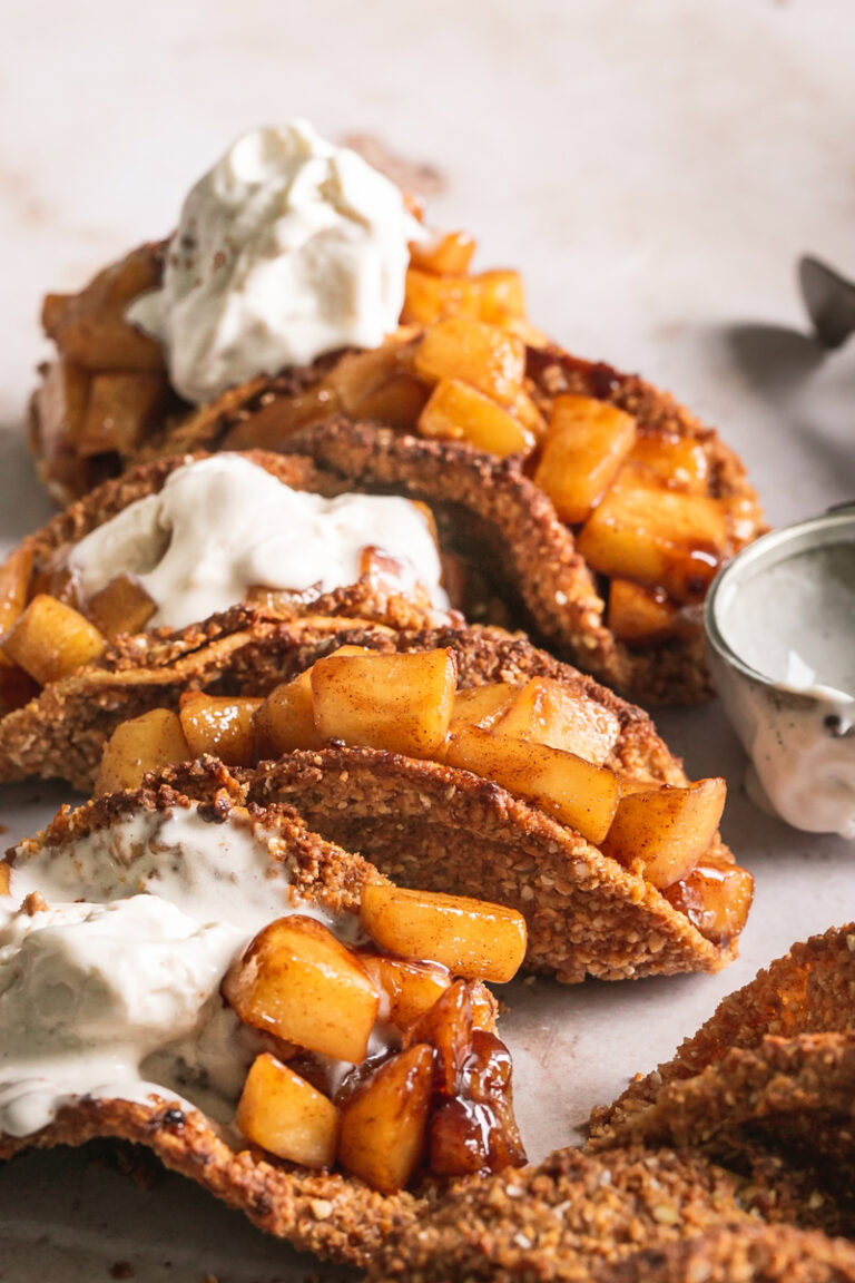 side view of apple pie tacos with a scoop of ice cream on top
