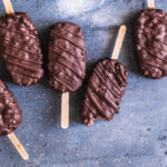 chocolate covered cocoa Krispie crunch pops lined up next to each other