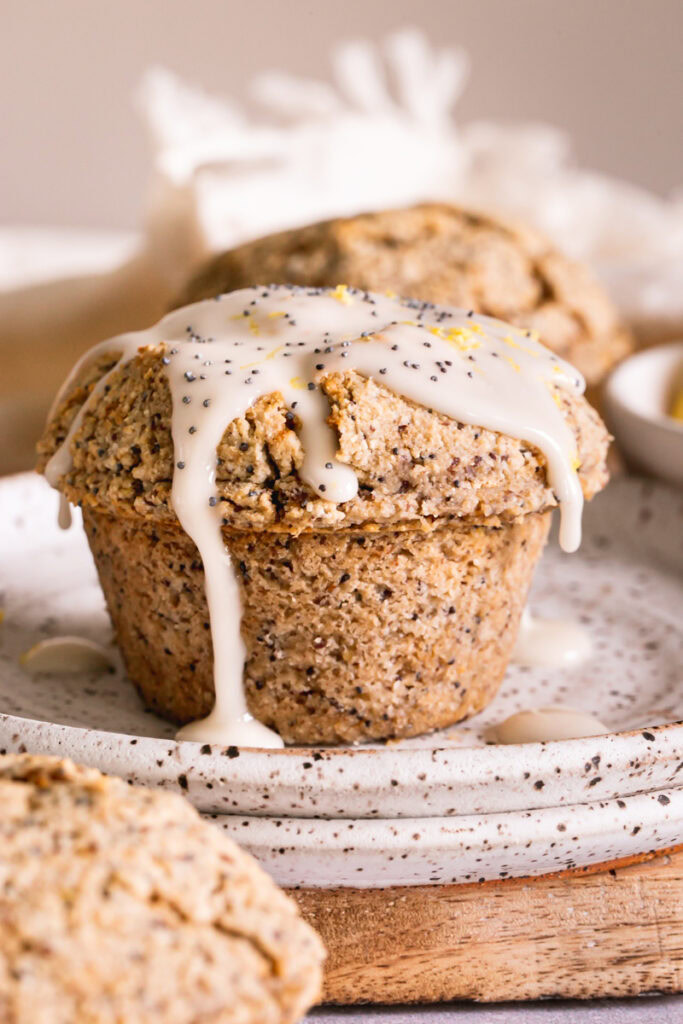 a close up image of a lemon poppy seed muffin drizzled with icing