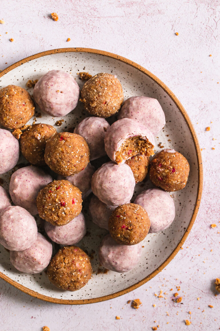 close up of strawberries and cream granola bites one with a bite taken out of it