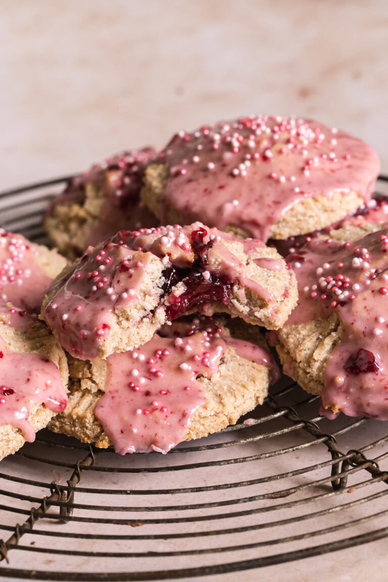 a head on image of cherry pop tarts with a bite out of the front one revealing the cherry filling
