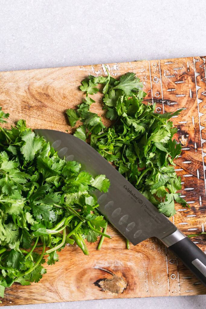 action shot of hands chopping cilantro