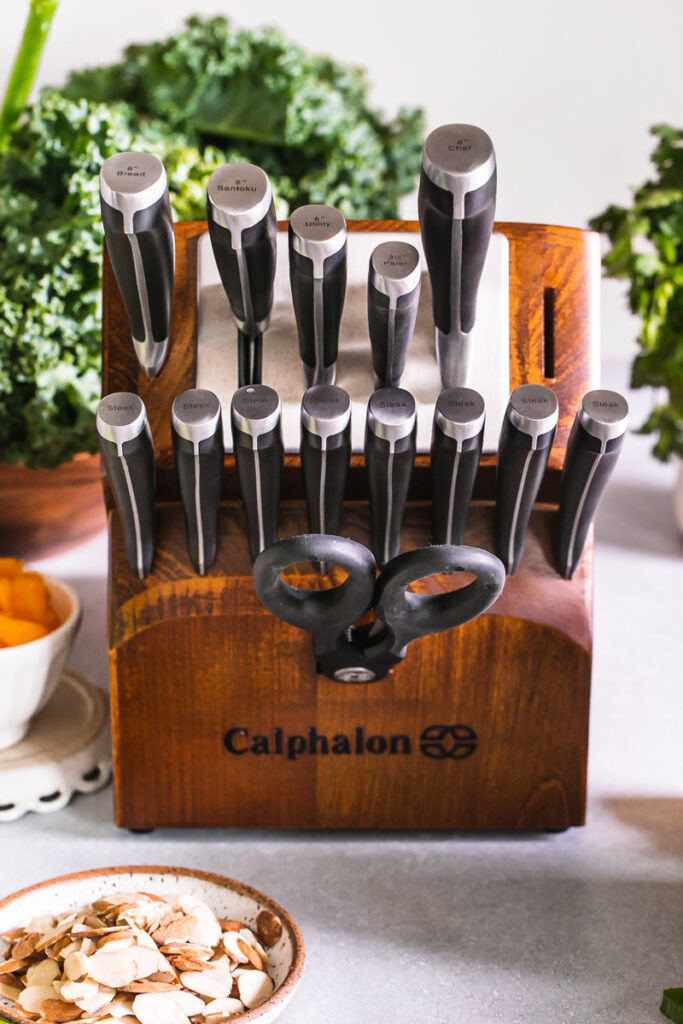 a block of Calphalon knives with fresh produce in the background