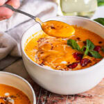 3/4 view with a spoonful of roasted creamy tomato carrot soup