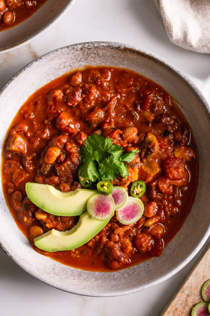 close up of a bowl of vegan three bean harissa pumpkin chili