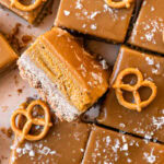 a close up overhead shot of sliced Salted Caramel Pumpkin Pie Bars, the middle one flipped on its side to reveal the pumpkin filling