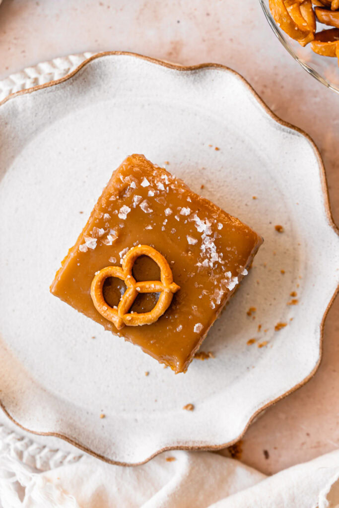 overhead shot of a slice of  Salted Caramel Pumpkin Pie Bars with Pretzel Crust on a plate