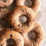 grain-free banana bread donuts piled on a round wire cooling rack