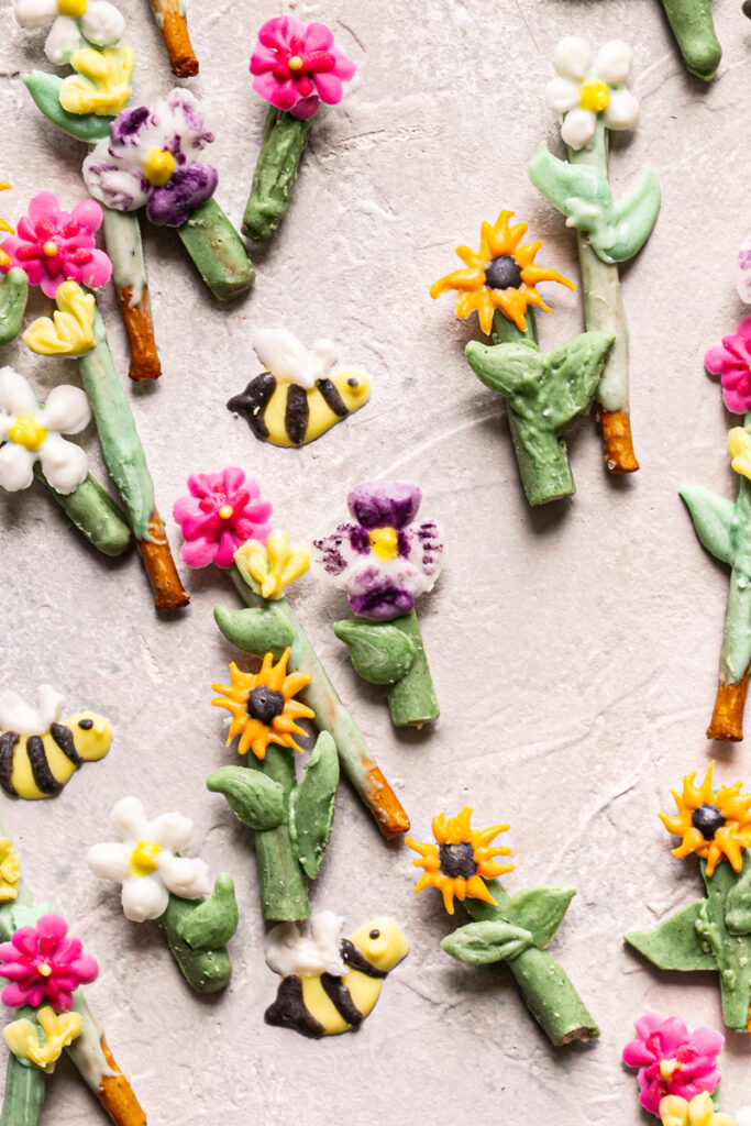 close up of flowers and bees painted with food colored vegan white chocolate