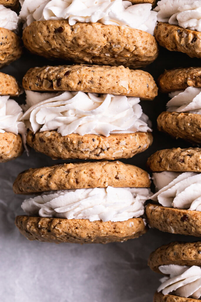 close up flatlay image of oatmeal sandwich cookies lined up next to one another