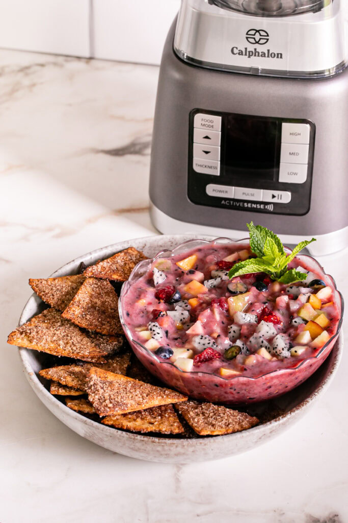 Air Fryer Churro Chips and Fruit Salsa in a bowl in front of the calphalon blender
