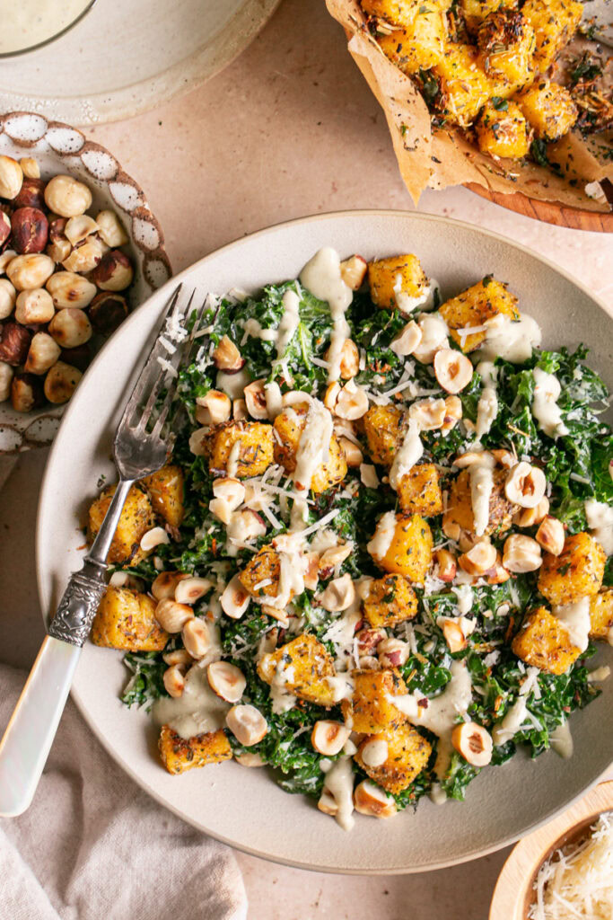 close up shot of Kale Caesar Salad with Polenta Croutons and Toasted Hazelnuts