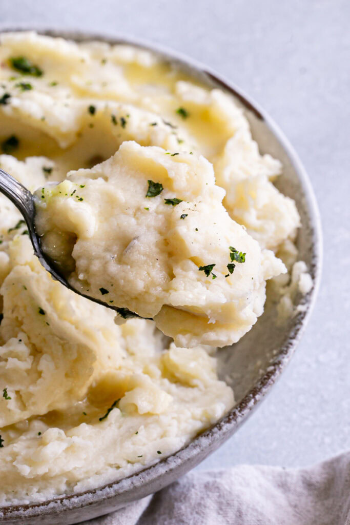 close up of mashed potatoes being scooped out with a spoon