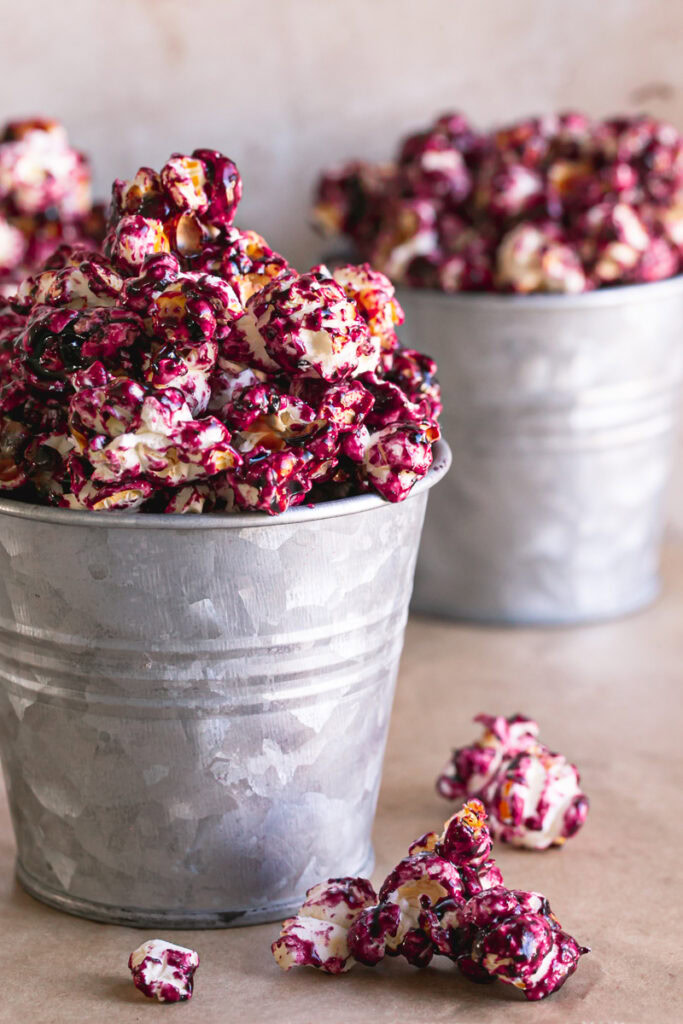 close up of Candied Haskap Berry Popcorn in buckets