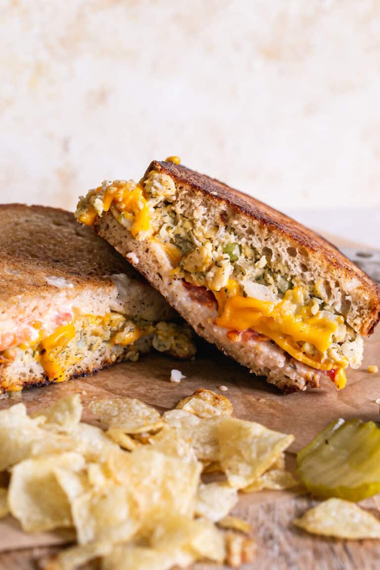 a grilled vegan tuna melt sandwich with chips and pickles
