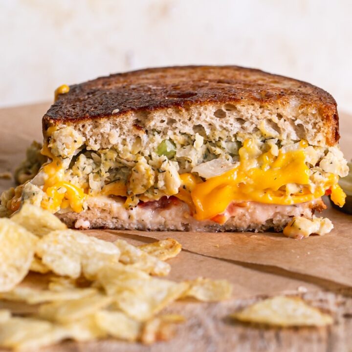 half of a chickpea tuna melt with potato chips