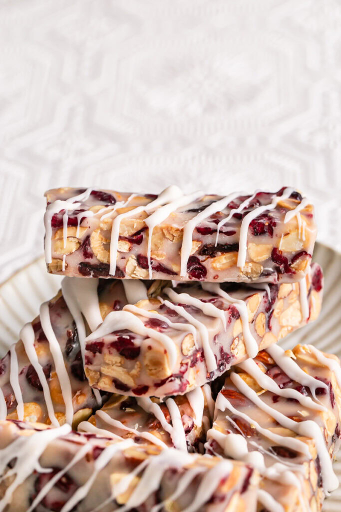White Chocolate Amaretto Trail Mix Truffle Bars stacked on top of one another on a plate