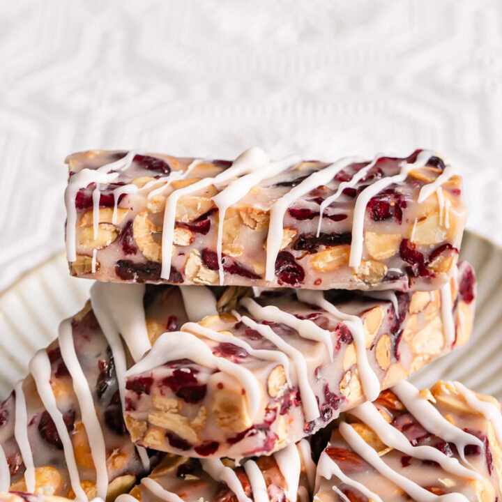 White Chocolate Amaretto Trail Mix Truffle Bars stacked on top of one another on a plate