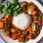 a close up of a bowl of sweet potato black eyed pea curry