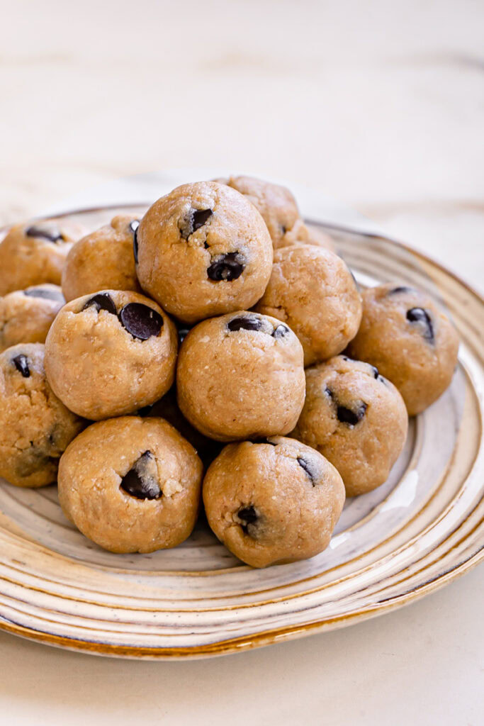 almond flour chocolate chip cookie dough bites piled on top of one another on a plate