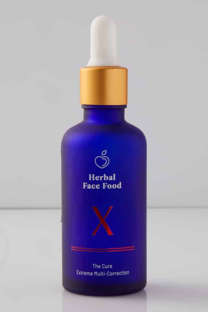 a bottle of herbal face food cure X serum