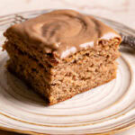 a square slice of maple tahini banana bread bars on a plate with a fork on it