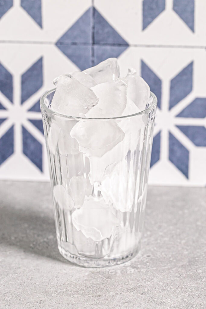 a glass filled with ice cubes