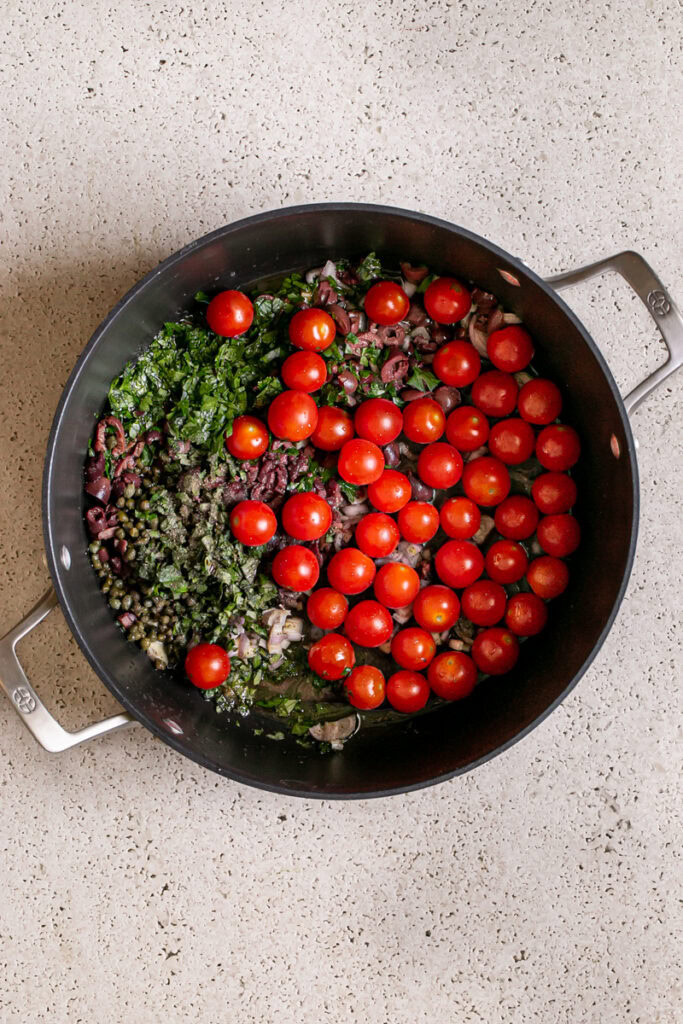 all of the ingredients to make the Cherry Tomato Puttanesca in a large stock pot