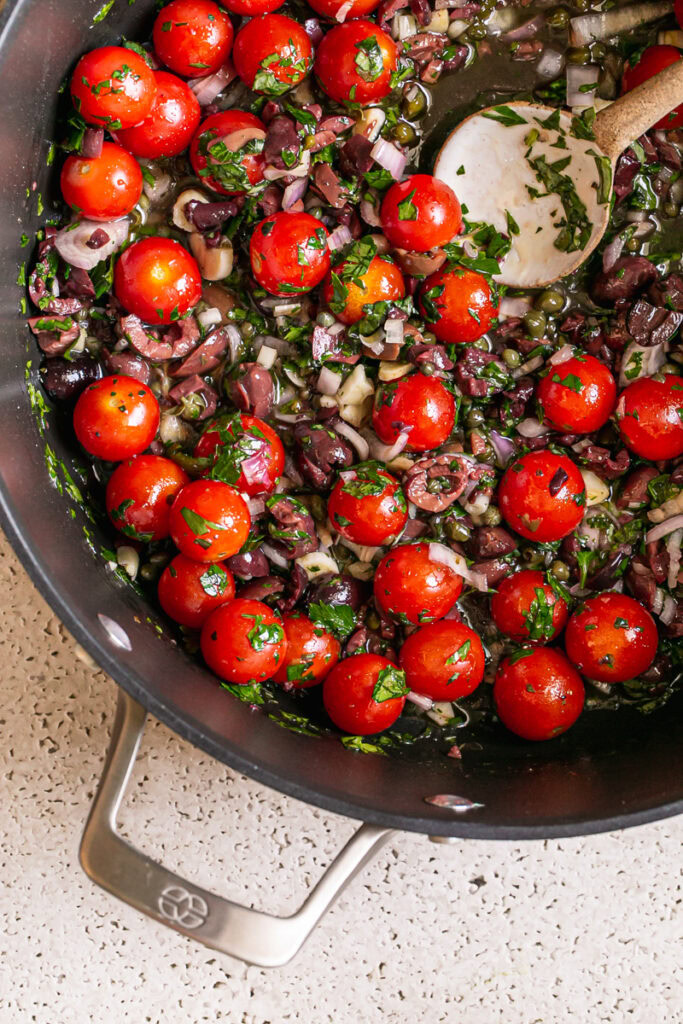 close up of all of the ingredients to make the Cherry Tomato Puttanesca in a large stock pot