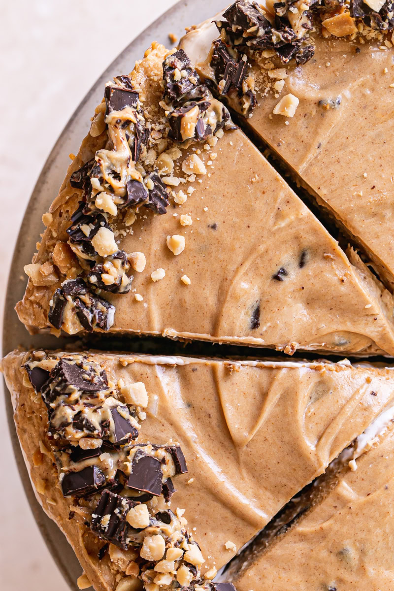 an overhead shot of sliced No-Bake Peanut Butter Cup Pie garnished with chopped peanut butter cups and peanuts