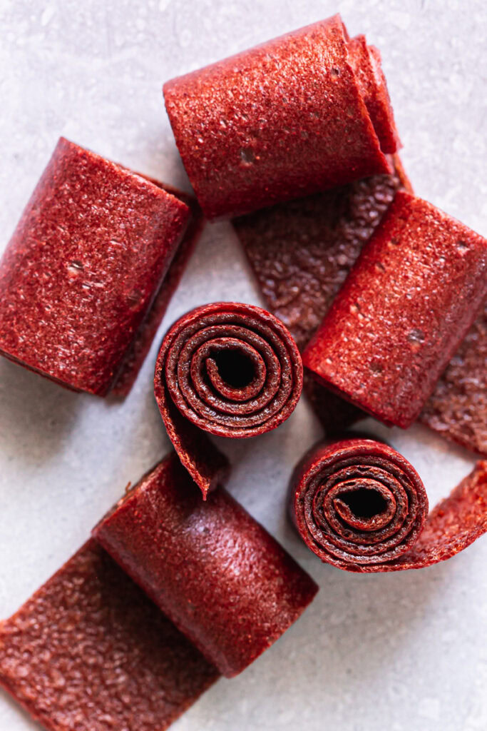 overhead shot of Strawberry Mango Fruit Leather (Fruit Roll-Ups) rolled up