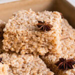 chai Rice Krispie treats sliced into squares piled in a square baking dish garnished with star anise