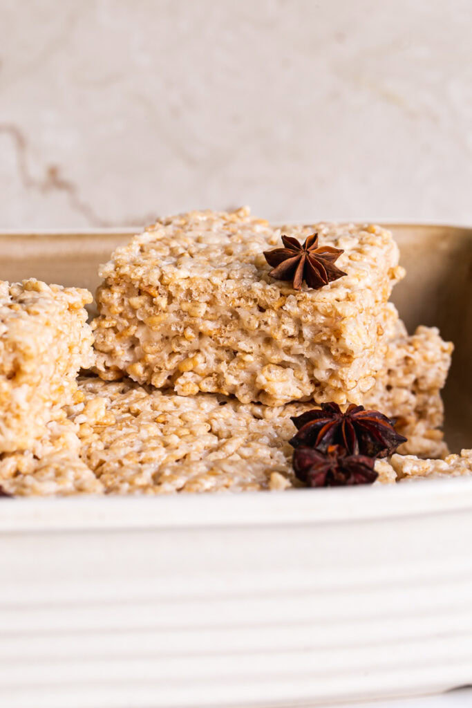 chai Rice Krispie treats sliced into squares piled in a square baking dish garnished with star anise