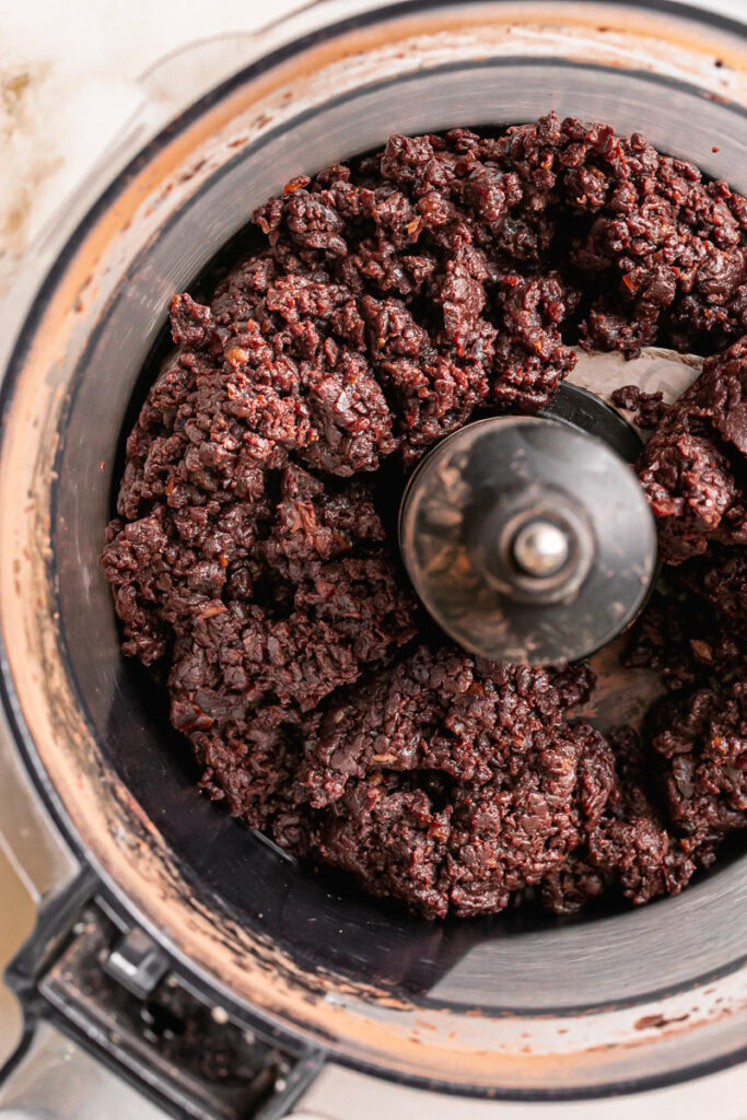 ground up dates with cacao powder, sunflower seed butter, and vanilla extract in a food processor