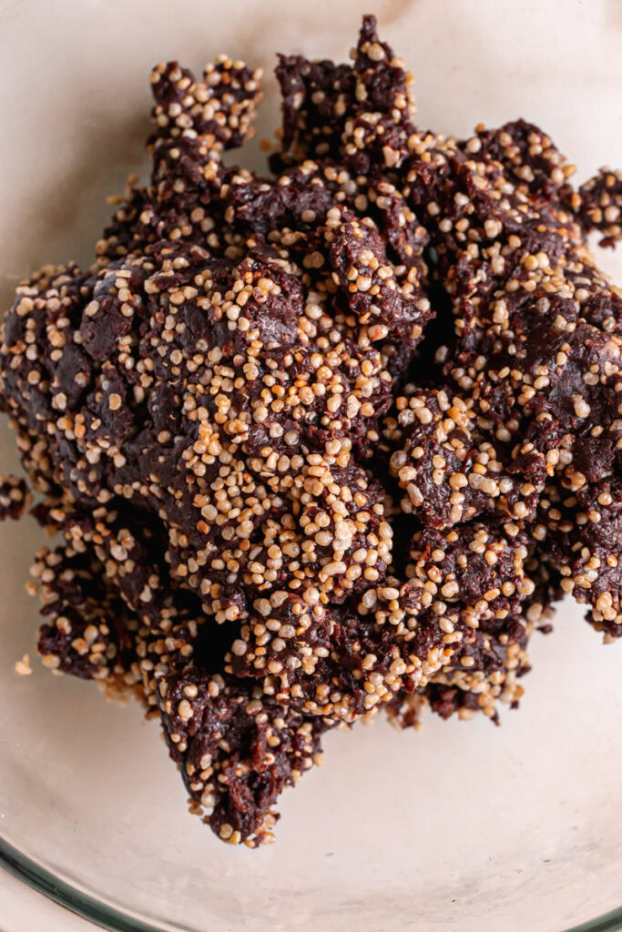 the ground up date cacao mixture combined with puffed quinoa in a large bowl