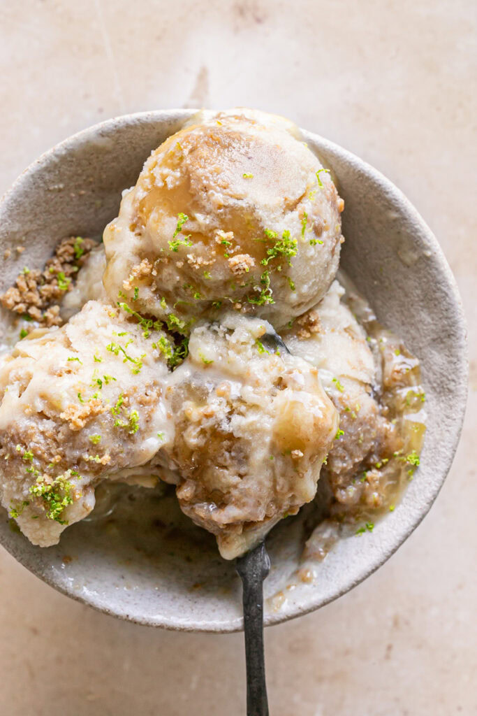 spoonful of No-Churn Key Lime Pie Ice Cream in a bowl with 2 other scoops