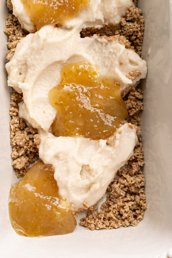 lime curd dolloped on top of the vegan vanilla ice cream and cookie dough crumble in a loaf pan