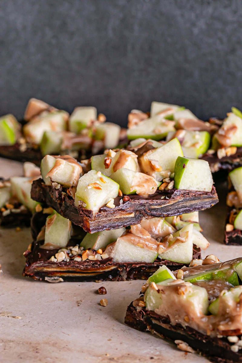 two squares of caramel apple date bark stacked on top of each other