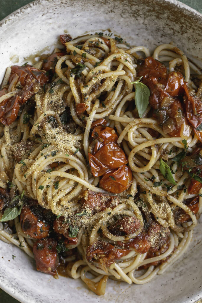 very close up overhead shot of cherry tomato bruschetta pasta.