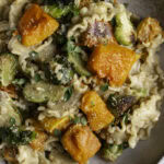 a very a close up of a bowl of Buttery Butternut Squash and Brussels Sprouts Pasta