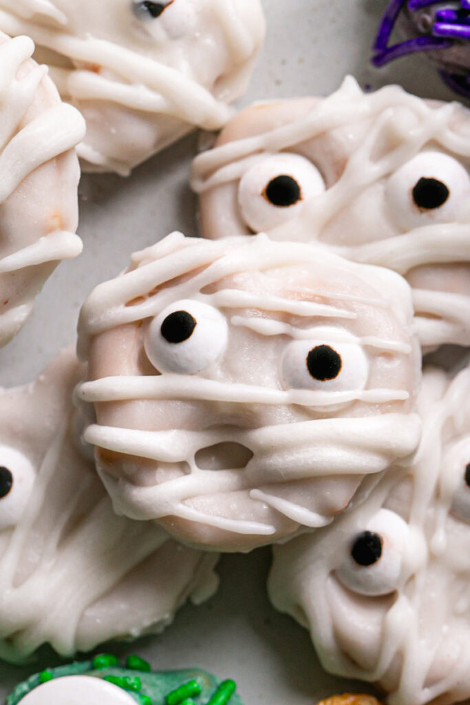 White chocolate covered pretzel mummies with candy eyes