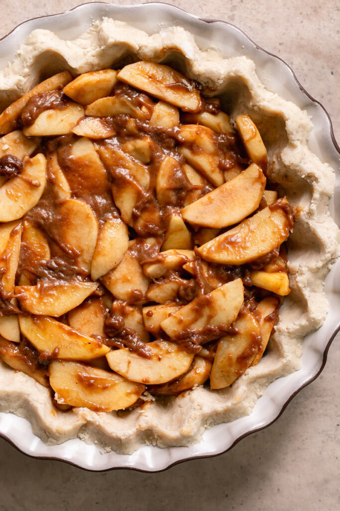apple pie filling in an unbaked gluten free vegan pie crust