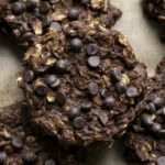 a close up of no-bake pumpkin brownie oatmeal cookies stacked on top of one another